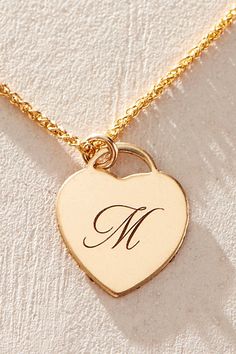 Just as effortless as it is elegant, this stunning necklace features a heart-shaped pendant with gorgeous cursive engraved initial for the ideal finishing touch. * 14k Gold Filled wheat chain * Personalized, laser engraved, 14k Gold Filled 12x14mm heart charm * Length: 18" * 5 days of production | Set & Stones Personalized Alice Necklace at Free People in Gold Yellow Gold Heart Charm Necklaces Personalized Gift, Personalized Yellow Gold Heart Pendant Charm Necklace, Gold Engraved Heart Pendant Initial Necklace, Wheat Necklace, Heart-shaped Yellow Gold Charm Necklace For Personalized Gift, Personalized Heart-shaped Brass Necklaces, Initial M, Engraved Initials, Stunning Necklace