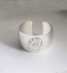 "This custom engraved cuff bangle will spell out your monogrammed initials in pretty script font. For different engraving, please inquire. Bangle will be amazing personalized gift for any occasions: graduation, birthday, Christmas, wedding, etc. Inside Diameter: 2.5\" (60mm adjustable) Bangle Width: 1.5\" mm (40mm) Metal Material: Sterling Silver ------ NOTE --------- Traditional monograms are made with the following order of initials taken from your name: FIRST, LAST, MIDDLE We assume that this Classic Name Bracelet With Initials For Anniversary, Customizable Classic Jewelry For Wedding Gift, Elegant Sterling Silver Name Bracelet With Engraving Option, Elegant White Gold Name Bracelet With Engraving Option, Elegant Silver Bangle With Engraving Option, Elegant Adjustable Bangle With Engraving Option, Classic Sterling Silver Cuff Bracelet For Wedding, Classic Cuff Bracelet Gift, Elegant Silver Name Bracelet With Engraving Option