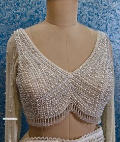 This Made to Order/Made to Measurement/Custom Made Indian Ethnic Blouse. - Fabric - Shimmer Georgette - Color - Champagne - Fully Hand Embroidered Beads and Sequins Work - Full Length Sleeves - Padded - Deep V Neck  - Back Hook Closure  - Princess Cut - Shoulder Strings with Latkans - Beads Fringes around the waist PLEASE NOTE: BUYERS ARE RESPONSIBLE FOR ANY CUSTOMS AND IMPORT TAXES THAT MAY APPLY.  This is a made to order product. If you opt for 'Made To Measurement Option', we will provide a measurement template and you can share the measurements likewise. If you want to opt for 'Standard Size', Please refer to the size chart provided in the listing. Shipping: Standard Shipping is done by DHL ecommerce and it mostly takes 2 to 3 weeks to deliver after dispatch. Express Shipping is done b Beads Blouse Design, Beads And Sequins Embroidery, Embroidered Beads, Saree Lehenga, Embroidered Saree, Beaded Blouse, Lehenga Blouse, Blouse Designs Latest, Color Champagne