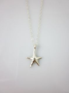 A sterling silver star charm hangs on a dainty sterling silver chain and closes with spring clasp. Simple and chic everyday jewelry. Charm measures: 16 x 10 mm Total length of necklace : 17 inches All components are sterling silver. All items are shipped in a gift box via registered mail. Thanks for looking. Please have a look at more items in the shop: http://smoketabby.etsy.com Star-shaped Sterling Silver Jewelry With Lobster Clasp, Sterling Silver Starfish Charm Necklace, Minimalist Starfish Charm Jewelry, Sterling Silver Star Charm Necklace Nickel Free, Sterling Silver Starfish Necklace With Star Charm, Nickel-free Sterling Silver Star Charm Necklace, Sterling Silver Star Charm Necklace For Everyday, Sterling Silver Necklace With Starfish Charm, Everyday Sterling Silver Star Charm Necklace