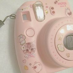 a pink camera sitting on top of a table