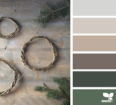 three wreaths made out of branches on a wooden table with the colors green, grey and white