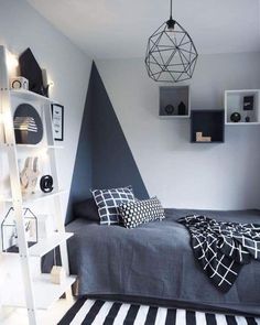 a bedroom with black and white decor on the walls, striped rugs and shelves