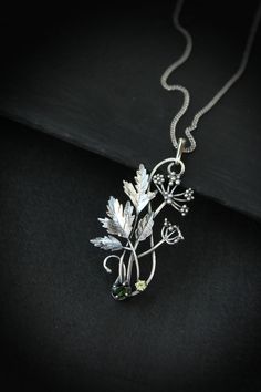 ITEM DESCRIPTION: The size H 5 cm x W 3 cm (2 x 1 1/3 inch). Weight - 5 g. You can buy it with a silver chain or without it. Even simple plants look very elegant. I made one of sterling silver, pretty green tourmaline, and peridot. This unique botanical jewelry looks like a real treasure of wild forest. It is really worthy of being in your precious collection. Expect many compliments on this! This handmade necklace will come to you in a gift box - ready for gifting. The parcel will be sent durin Green Sterling Silver Flower Pendant Jewelry, Silver Round Pendant Jewelry With Nature-inspired Style, Silver Nature-inspired Round Pendant Jewelry, Nature-inspired Metal Pendant Necklace, Nature-inspired Sterling Silver Pendant Jewelry, Nature-inspired Sterling Silver Pendant Necklace, Nature-inspired Sterling Silver Jewelry With Large Pendant, Nature-inspired Sterling Silver Leaf Necklace, Botanical Sterling Silver Jewelry Gift