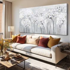 a living room filled with furniture and a large painting on the wall above the couch