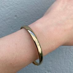 An adult-size plain polished 14K yellow gold-filled bangle bracelet. The outer shell is solid gold pressure-bonded to an inner core of high-quality brass. Guard and hinge Width: 6 mm Circumference: 7" Hypoallergenic Gold Bangle, Everyday 14k Gold-filled Bangle Bracelet, Minimalist Yellow Gold-plated Bangle, Adjustable Gold-plated Bangle With Polished Finish, Gold-tone Tarnish Resistant Cuff Bangle, Inner Core, Bangle Bracelet, Bangle Bracelets, Solid Gold