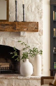 a living room with a fireplace and bookshelf