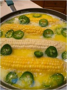 corn on the cob with peppers and jalapenos in a skillet