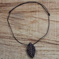 Drawing inspiration from nature artisan Ralph Ashong presents this attractive pendant necklace that is ideal for a casual look. Crafted by hand from local sese wood the leaf-shaped pendant is engraved with eye-catching lines and swirls that resemble the venation on a leaf. The sleek pendant hangs from an adjustable nylon cord making it a versatile accessory for men and women. Wood Leaf, Inspiration From Nature, Scrap Material, Wood Carving Art, Sliding Knot, Creative Skills, Wood Pendant, Coconut Shell, Ceramic Jewelry