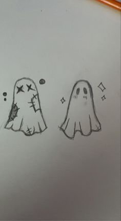 the drawing shows two ghost faces, one is drawn in pencil and the other is drawn with colored crayons