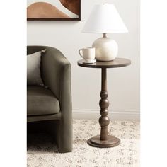 a table with a lamp on it next to a couch