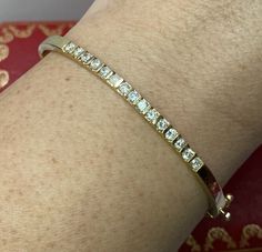 14k Yellow Gold Diamond Bangle 7.25” Lavish her with luxury with this stunning bracelet! There are 15 rounds diamonds approximately 3/4 - 1 carat approx. VS-SI and color E-F. The inside circumference measures approx. 7.25”. Stamped 14k KD 1.03 with a serial number. The 1.03 stamp is most likely for the carat weight of the piece. Weighs 14 grams. Includes a beautiful gift box. A gorgeous bracelet! Note: Diamond quality and carat weight can vary slightly in opinion (please allow for a slight varia Classic Hallmarked Cuff Bracelet For Wedding, Yellow Gold Channel Set Bracelets For Wedding, Classic Channel Set Diamond Bracelet For Wedding, Classic Wedding Cuff Bracelet With Single Cut Diamonds, Classic Wedding Bangle With Vvs Clarity, Classic Diamond Cuff Bracelet For Wedding, Classic Wedding Cuff Bracelet With Diamond Accents, Wedding Diamond Bangle Channel Set, Adjustable Wedding Diamond Bracelet With Single Cut Diamonds