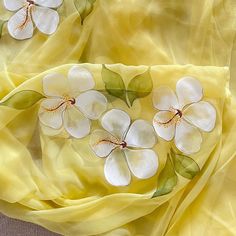 the fabric is yellow with white flowers on it