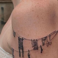 a woman's back with clothes hanging on a line