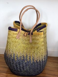 These beautiful pieces are designed in South Africa. Handmade with raffia and featuring leather handles, these bags bring the perfect mix of bohemian chic to everyday wear! Capable of being used as a handbag, basket or storage-this multi-purpose piece is a cannot miss! The double closure top provides a multi-style capability as well! Sizing: 16 inches wide x 12 inches deep x 13 inches high Bohemian Bucket Bag With Leather Handles For Vacation, Bohemian Straw Bag With Double Handle, Bohemian Woven Satchel Beach Bag, Artisan Beach Bag With Adjustable Strap, Bohemian Satchel Beach Bag With Leather Handles, Bohemian Woven Straw Satchel Bag, Bohemian Straw Satchel Bag, Bohemian Straw Satchel Bag With Handles, Bohemian Straw Satchel With Handles