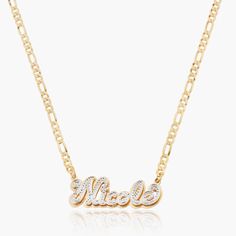 Our popular Double Plated Iced Out Script Name Necklace boasts a chic and elegant design, handcrafted to perfection. The model showcases the necklace with an 18-inch Cuban chain (see image for reference). Chain width:Cuban Chain - 3.7 mmFigaro Chain - 3 mmRope Chain - 2.3 mm Closure: All chains are fitted with a lobster clasp. Metal Selection: Gold Plated Silver Plated Sterling silver 14k gold plated over sterling silver 14k solid gold - (NAMEPLATE ONLY) Dainty Initial Necklace, Ring Bracelet Chain, Name Earrings, Engraved Pendant, Cross Chain, Photo Pendant, Jewelry Care Instructions, Chic And Elegant, Name Bracelet