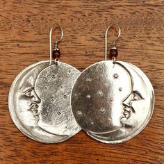 There are quite a few moonface earrings in Laurel's line - this one has the distinction of being the first. Brass with sterling silver plate, about 2" (2 1/2 fingers) tall. The revival earrings here are vintage stock from the 1970's - they were designed by the late artist Laurel Burch and crafted by hand. Nickel-free Adjustable Moon-shaped Jewelry, Nickel-free Adjustable Moon Shaped Jewelry, Silver Crescent Symbolic Earrings, Unique Metal Moon Phase Earrings, Unique Moon Phase Metal Earrings, Symbolic Silver Crescent Earrings, Celestial Nickel-free Earrings, Celestial Nickel-free Adjustable Earrings, Adjustable Celestial Nickel-free Earrings