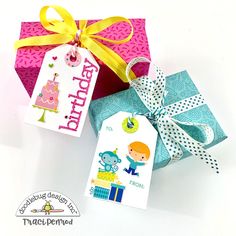 two gift boxes with tags attached to them