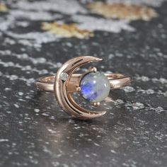 Mystical Cabochon Rings As A Gift, Mystical Anniversary Ring With Cabochon, Mystical Cabochon Ring For Anniversary, Magical Rose Gold Jewelry For Anniversary, Heirloom Crescent Jewelry For Gifts, Heirloom Crescent Jewelry Gift, Vintage Moonstone Ring Jewelry, Celestial Gemstone Jewelry Collectible, Collectible Celestial Gemstone Jewelry