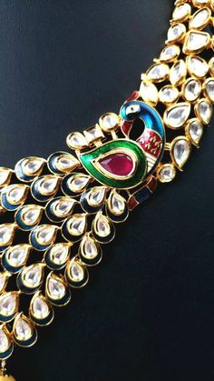 "Look resplendent on your wedding day or any day, wearing this beautiful peacock art deco inspired kundan collar necklace, with glittery kundan stones, meenakari (painted enamel), red crystal stones and large pearls. The peacock's splendid is tail incorporated into the design. You will receive so many compliments wearing this necklace set. Equally fabulous peacock earrings! Excellent quality, this is a a substantial piece, on the heavier side, but it sits flat, comfortably on the collar bone. Co Wedding Kundan Bridal Necklace With Peacock Design, Wedding Bridal Necklace With Kundan And Peacock Design, Festive Kundan Necklace With Peacock Design For Wedding, Traditional Kundan Necklace With Peacock Design For Wedding, Silver Kundan Necklace With Peacock Design For Wedding, Kundan Temple Jewelry Sets With Peacock Design, Festive Ceremonial Kundan Necklace With Peacock Design, Peacock Design Necklaces For Weddings And Festivals, Kundan Jewelry Sets With Peacock Design