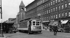 an old black and white photo of trolleys on the street