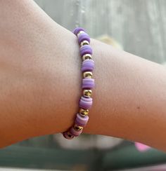 Clay bead bracelet with 2 shades of purple and gold beads in a repeating pattern. This bracelet is 2 inches in diameter and would be suitable for a child or young adult/adult with a smaller wrist. There is a little stretch, but not much. Trendy Purple Jewelry With Tiny Beads, Casual Purple Hypoallergenic Bracelets, Adjustable Purple Bracelets With Tiny Beads, Adjustable Purple Bracelet With Tiny Beads, Purple Stretch Bracelet With Letter Beads As Gift, Purple Stretch Bracelet With Letter Beads For Gift, Purple Stretch Bracelet With Round Beads As Gift, Adjustable Purple Stretch Bracelet For Friendship, Purple Beaded Bracelets With Spacer Beads As Gift