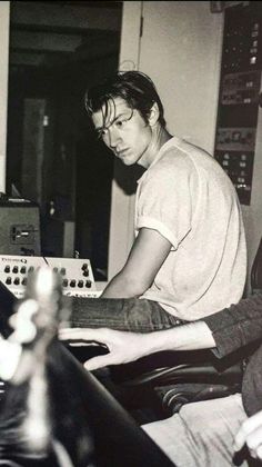 a man sitting in front of a mixing desk