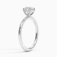 an oval shaped diamond engagement ring on a white background