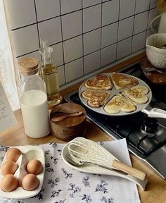 some food is sitting on a table with utensils and other kitchen items next to it