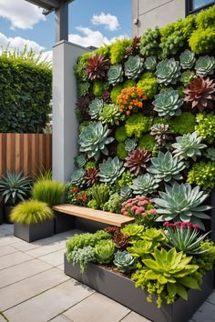 a large green wall with succulents and plants on it