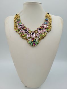 Each piece of our statement necklaces is handmade and one of a kind made in Italy. Our creations is made of high quality materials such as crystals and rhinestones. Each embroidered material is carefully hand sewn. Very glamorous and stylish. Perfect gift to someone you like. Materials Strass stone and Rhinestone in Rose, Rose opale, Green opale and Rainbow color in different dimension.  Black satin fabric backing. Aluminium chain with lobster closure. Measurements Weight approximate 200 grams. Chain lenght 25 cm - 9.84 in Circumference approximate 63 cm - 24.80 in Feel free to contact us if you have any question. Thank you so much for looking at our shop and our articles each of them, single piece. Bridal Pendant Necklace With 17 Jewels For Party, Gold Crystal Embellished Choker Necklace, Unique Pink Necklace For Party, Costume Jewelry Rhinestone Pendant Necklace For Party, Costume Jewelry Jeweled Choker Necklace, Gold Necklaces With Stones For Party, Handmade Bridal Choker Necklace, Handmade Bridal Choker For Party, Handmade Choker Bridal Necklace For Party