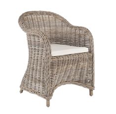 a wicker chair with white cushions