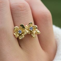 Title:  Cherry Blossom Ring Material: Solid Yellow 14K Gold, Rose 14K Gold, Natural unplated White Gold 14K Gold, or sterling Silver Timeline:  All pieces are made to order and set with sapphires, so they take about 2-3 weeks to make Size: Flowers are 10 mm tall at highest point, band is 1.2-1.3mm round Lab Maden Blue Sapphire Special Options: Other gems and more sizes or materials are available upon request. Reach out via messages or ameliarayjewelry@gmail.com Story:  This Cherry blossom ring f Gold Tanzanite Birthstone Ring For Anniversary, Delicate Gold Sapphire Ring For Anniversary, Yellow Sapphire Birthstone Ring For Anniversary, Anniversary Yellow Sapphire Birthstone Ring, Anniversary Yellow Sapphire Ring In Yellow Gold, Yellow Gold Tanzanite Birthstone Ring For Anniversary, Anniversary Jewelry With Rose Cut Diamonds And Tanzanite, Anniversary Yellow Gold Tanzanite Jewelry, Anniversary Yellow Sapphire Ring With Prong Setting