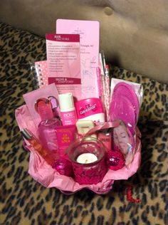 a pink basket filled with personal care items on top of a leopard print table cloth