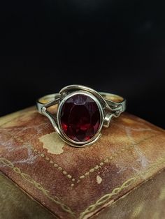 This beautiful vintage ring dates from the mid 20th century featuring an oval cut synthetic red Spinel or ruby gemstone set with floral mount in 9ct yellow gold marked 9ct.  UK size - P1/2 US size - 7.75 The gemstone has slight movement but well set and secure  Message me any questions Beautiful Rings Vintage, Red Spinel, Ruby Gemstone, Yellow Gold Ring, Vintage Ring, Bezel Setting, Yellow Gold Rings, Oval Cut, Rings Statement