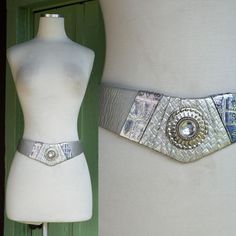 Rad Belt by Nina Arjani Circa 1980s Silver Leather  Wider at Front with Textured Material at Front Center Pinky & Purple Tones in Trim Large Rhinestone at Front Center Hooks & Holes to Secure  **Hooks are rusty. belt sold as is. Label: Leatherock Nina Arjani Designs Material: Leather Tag size may not be accurate to current day sizing, please refer to garment's measurements. Garments are measured laying flat - measurements doubled as necessary. Total Length: 33.5 in Best Fit: 28 in - 31.5 in All sales are final.  Our items are Vintage, meaning they have been around 20+ years. Due to the passage of time, and previous wear, they may have some resulting flaws or imperfections. Please read store policies and item description before purchase. If you have questions, would like to know more detail Suspender Belt, Y2k Fashion, Leather Belt, Dream Clothes, Favorite Things Gift, Vintage Outfits, Im Not Perfect, Accessory Gift, Outfit Accessories