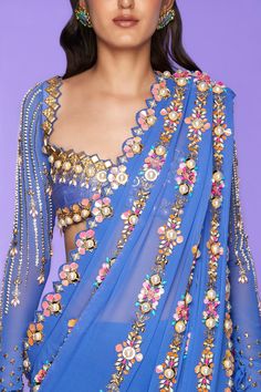 A classic studded pre-stitched blue saree in georgette and tulle bottom embellished with reflective acrylics, pearls, sequins, and glass cut crystals. Paired with a full sleeve blouse embellished in metal pieces, pearls, and crystals.From Papa Don’t Preach’s Nazar Na Lage collection. DELIVERY TIMEPlease allow 8-12 weeks for your outfit to arrive. FABRIC DETAILSGeorgette, Tulle Professional cleaning only. Papa Don't Preach, Saree Drape, Bal Gopal, Simple Lehenga, Illustration Collage, Full Sleeve Blouse, Fancy Saree, Dresses Traditional, Embellished Fashion