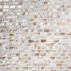 a close up view of a tile wall with white and brown tiles on the side