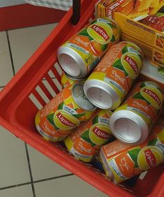 several cans of orange juice in a shopping cart