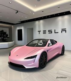 a pink tesla sports car in a showroom