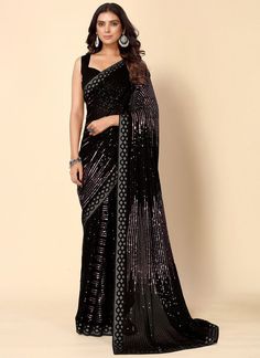 Product Features: Saree Color: Black Blouse Color: Black Saree Fabric: Georgette Blouse Fabric: Dupion Saree Work: Sequins Work Saree Type:Woven Saree Border: Lace Border Pallu Style: Fancy Pallu Wash Care: Dry Clean Occasion: Party wear Product Type: Saree Disclaimer: There will be slight difference in digital to actual image Festive Black Pre-draped Saree With Cutdana, Glamorous Black Fitted Pre-draped Saree, Black Pre-draped Saree With Pallu For Festive Occasions, Navratri Saree With Sequins, Festive Black Pre-draped Saree With Self Design, Black Pre-draped Saree For Festivals With Unstitched Blouse, Black Georgette Bollywood Pre-draped Saree, Black Sequined Pre-draped Saree, Black Cutdana Blouse For Reception