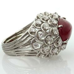 For Sale on 1stdibs - This captivating ring from David Webb features an open-design dome crown prong-set with an oval 11.0mm x 15.0mm cabochon ruby and surrounded by 36 sparkling Cabochon Ruby, David Webb, Womens Ring, Ruby Diamond Rings, Coral Ring, Dome Ring, Gold Clips, Domed Ring, Ruby Diamond