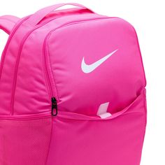 Grab your gear and get going with the Nike Brasilia Backpack. It has plenty of pockets to help you stay organized, including a sleeve to fit your laptop, side mesh pockets for water bottles, and a zippered pocket on the inside to keep small items secure. This product is made with at least 50% recycled polyester fibers. Haul loop at the top. Spacious main compartment. Padded, adjustable shoulder straps. Front zip pocket. Internal laptop sleeve. Dimensions: 18" H x 12" W x 7" D. Capacity: 24 L. Sh Nike Functional Backpack For Outdoor Activities, Pink Functional Outdoor Backpack, Functional Pink Outdoor Backpack, Sporty Pink Backpack For School, Pink Bags For Outdoor And Back To School, Sporty Pink School Backpack, Nike Nylon Backpack For Travel, Nike Nylon Travel Backpack, Pink Nylon Outdoor Backpack