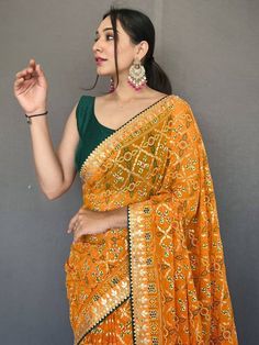 Get ready for any event with our attractive yellow printed georgette event wear saree with a blouse! This stunning saree comes in a light and breezy georgette material with a bandhani print all over. It also features a gotta pati lace border and tassels work for a beautiful finish. The set also includes a green blouse made of georgette material and features a gotta patti lace border. With a versatile 5.50 meters long saree and stitched 1.00 meters blouse, you can dress this saree up or down for Fitted Yellow Pre-draped Saree With Pallu, Festive Yellow Fitted Pre-draped Saree, Yellow Georgette Pre-draped Saree With Pallu, Transitional Designer Yellow Pre-draped Saree, Yellow Chinon Pre-draped Saree, Fitted Yellow Pre-draped Saree With Mirror Work, Fitted Yellow Pre-draped Saree For Festivals, Yellow Fitted Saree With Mirror Work, Fitted Yellow Saree With Mirror Work