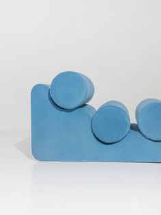 a blue sculpture sitting on top of a white floor