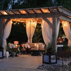 an outdoor patio covered in white curtains and string lights with text overlay that reads best ways to protect your patio furniture