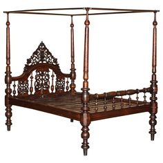 an antique wooden bed frame with four posts