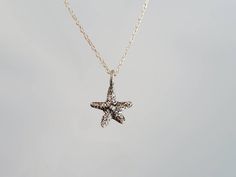 "Tiny sterling silver starfish pendant. The sterling silver charm is a dainty 9mm with a shiny finish. It has a delicate sterling silver chain and clasp. Shown here in 17\" length. *If you are unsure of the length you need, or would like to wear this item at different lengths, we now offer an adjustable length option! You can add an adjustable end to your necklace using this link: https://www.etsy.com/listing/791277751/necklace-extension-added-to-your All items are gift wrapped and shipped witho Sterling Silver Starfish Charm Necklace, Sterling Silver Starfish Necklace With Star Charm, Sterling Silver Necklace With Starfish Charm, Necklace Extension, Starfish Pendant, Starfish Necklace, Solid Gold Jewelry, Jewelry Cleaner, Necklace Sterling Silver