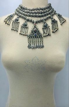 *The silver tribal necklace is one of the most engaging jewelry pieces we have in our collection. This semi-silver tribal necklace is one of the most adored pieces in our collection. The pendants and silver drooping tassels with antique designs and glass stones. Above all the beaded multilayers make this tribal piece a worth admiring piece for our consumers. *Made up of the best quality of metal alloy this multilayer choker necklace takes us back to ancient times. The antiquity and grace of this Traditional Silver Beaded Jewelry, Multicolor Bohemian Jewelry With Intricate Design, Silver Jewelry With Jewels For Festivals, Bohemian Pendant Jewelry For Rituals, Spiritual Festival Jewelry With Dangling Beads, Festival Silver Necklace With Jewels, Handmade Silver Traditional Beaded Necklaces, Bohemian Silver Beads Necklaces For Rituals, Handmade Traditional Silver Beaded Necklaces