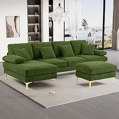 a large green couch sitting on top of a rug